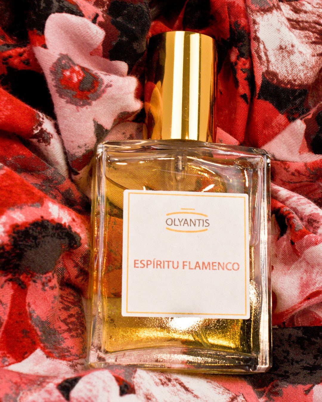 Espíritu Flamenco 60 ml Eau de Parfum flat on red, floral silk. 