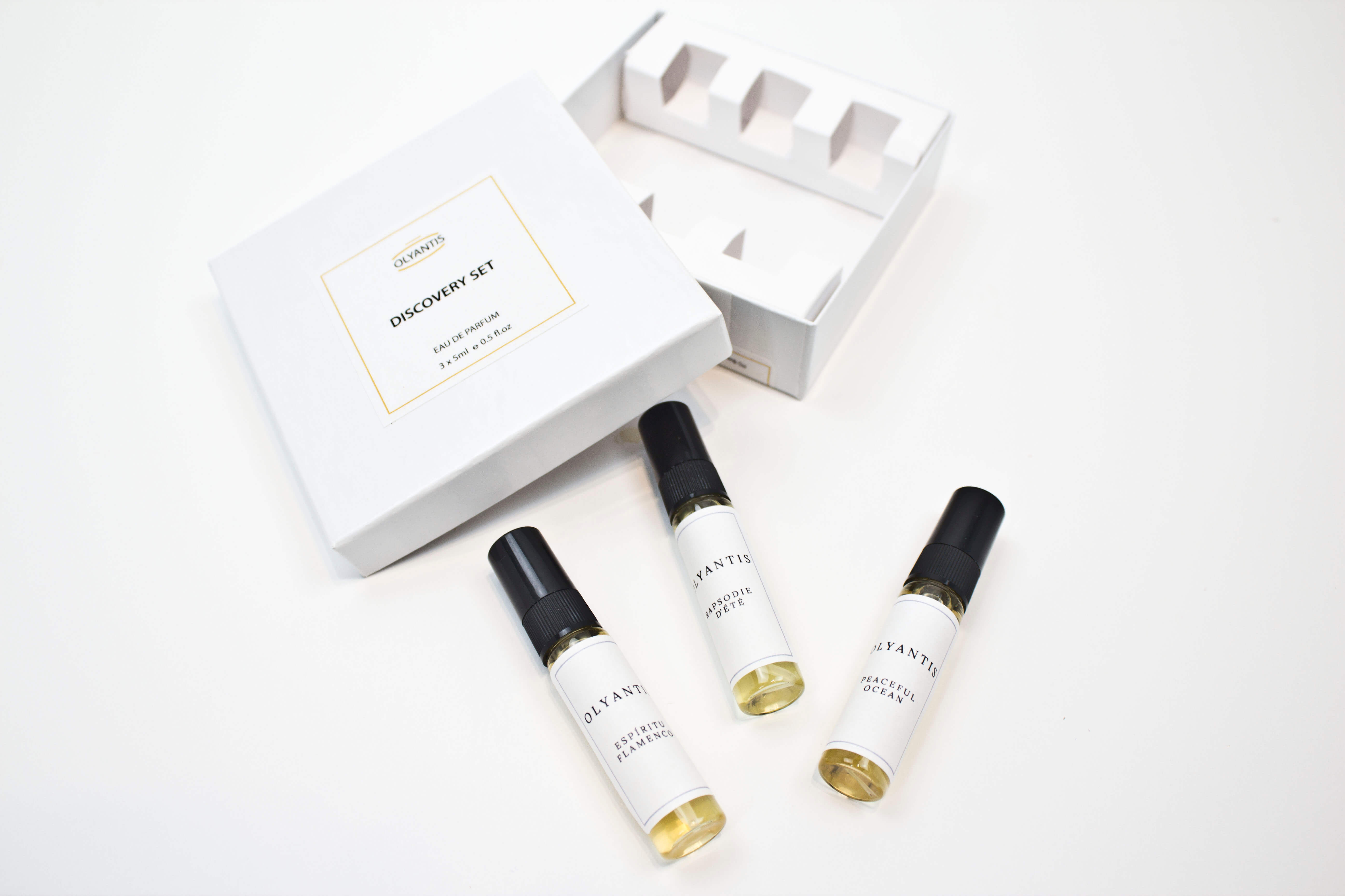 Olyantis's white box labeled Discovery Set containing three 5 ml glass bottles, arranged on a clean white background. The box is opened, showing the 3 perfume samples. 