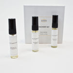 Olyantis's Discovery Set of 3x 5 ml perfume glass bottles, spaced, standing up in front of its white box. 