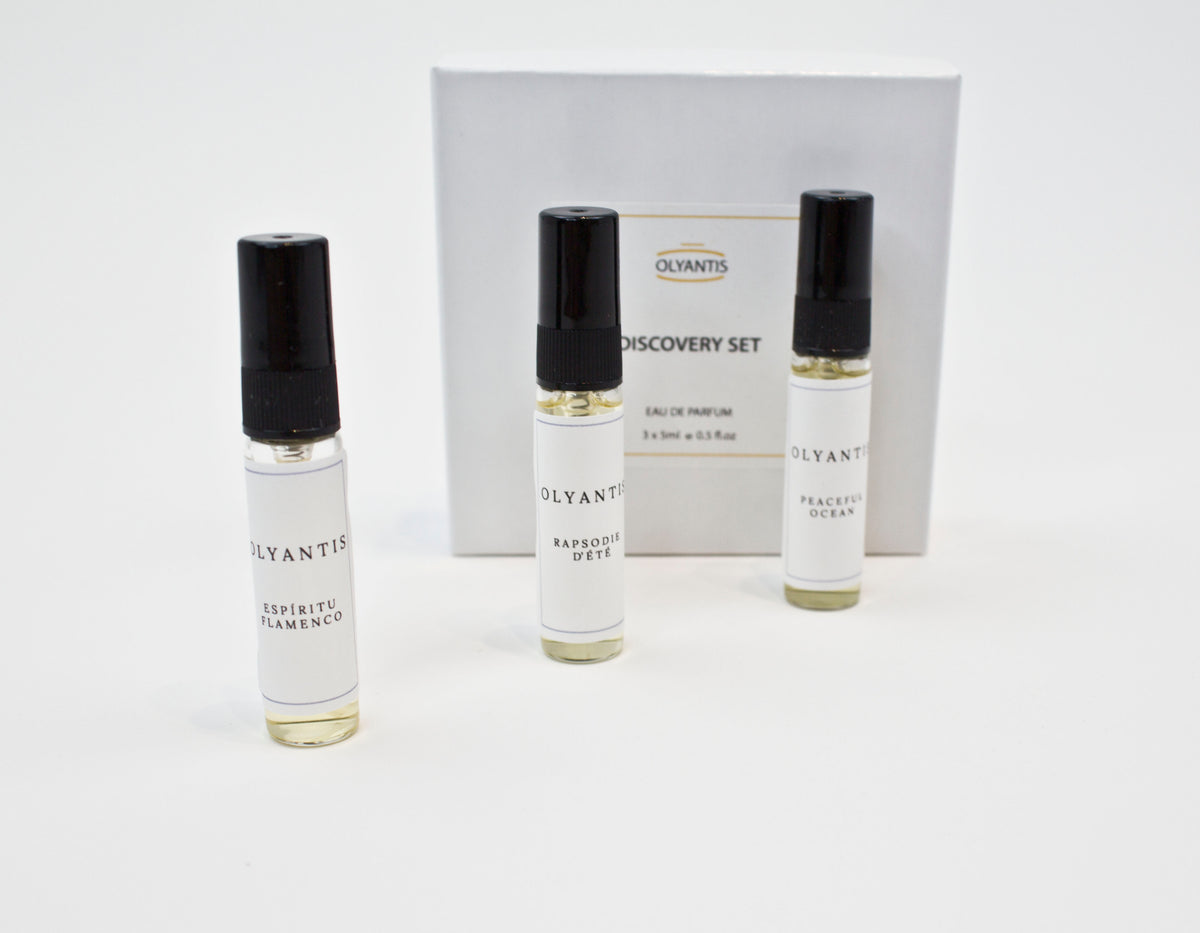 Olyantis's Discovery Set of 3x 5 ml perfume glass bottles, spaced, standing up in front of its white box. 