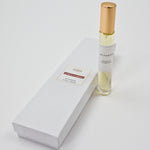 Olyantis's Espíritu Flamenco 10 ml perfume glass bottle with gold cap beside its paper box.