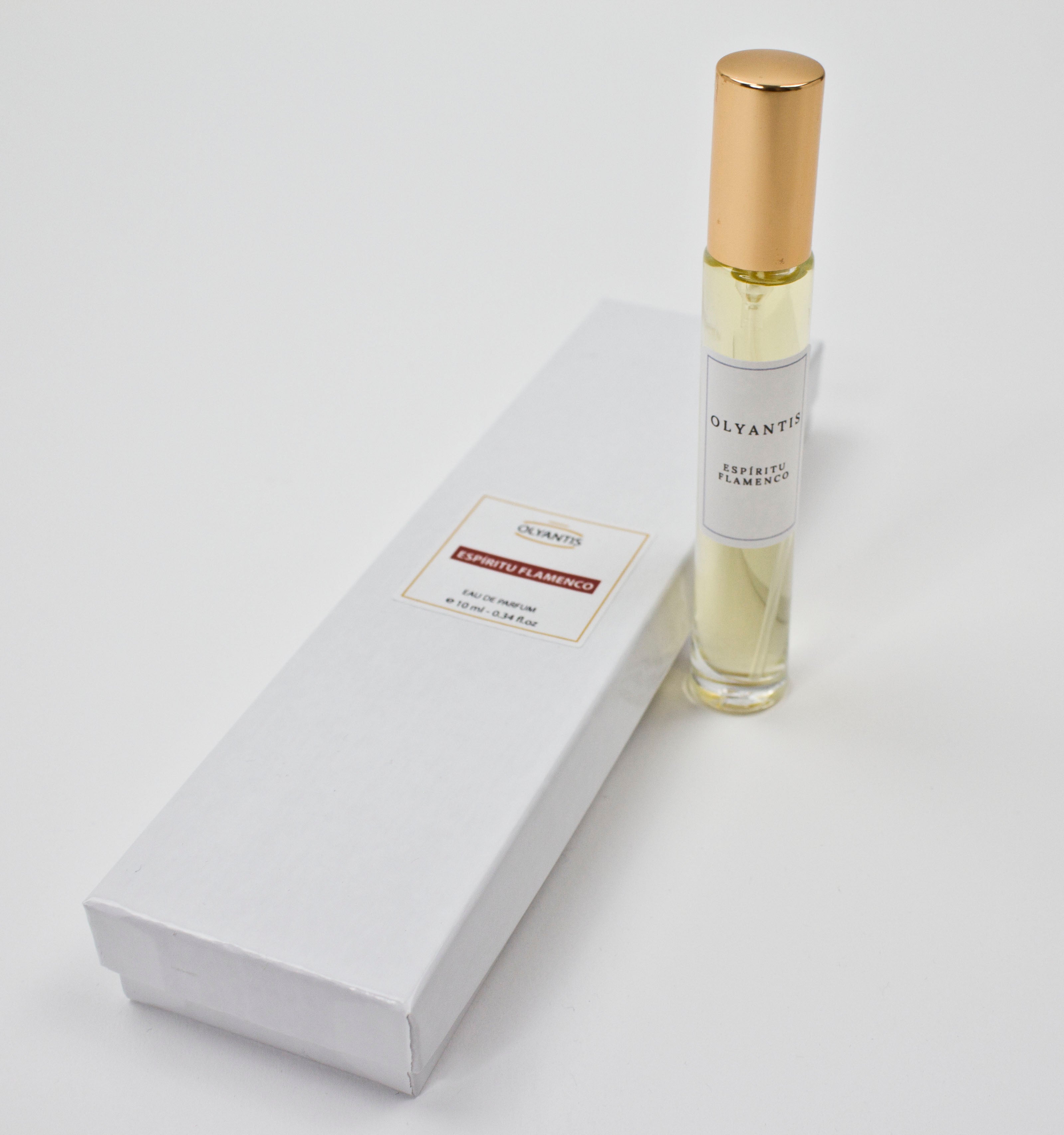 Olyantis's Espíritu Flamenco 10 ml perfume glass bottle with gold cap beside its paper box.