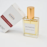 Olyantis's Espíritu Flamenco 60 ml perfume glass bottle with gold cap beside its paper box.
