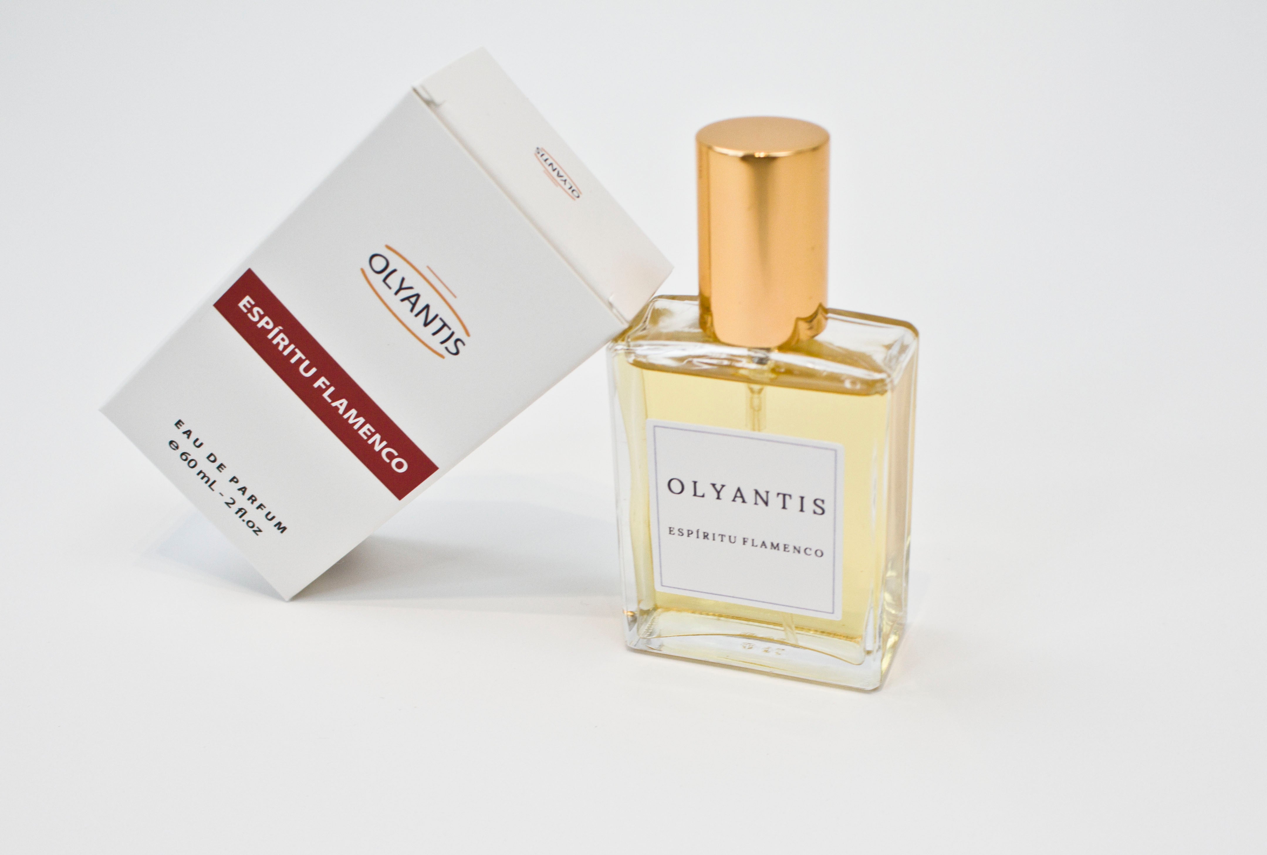 Olyantis's Espíritu Flamenco 60 ml perfume glass bottle with gold cap beside its paper box.
