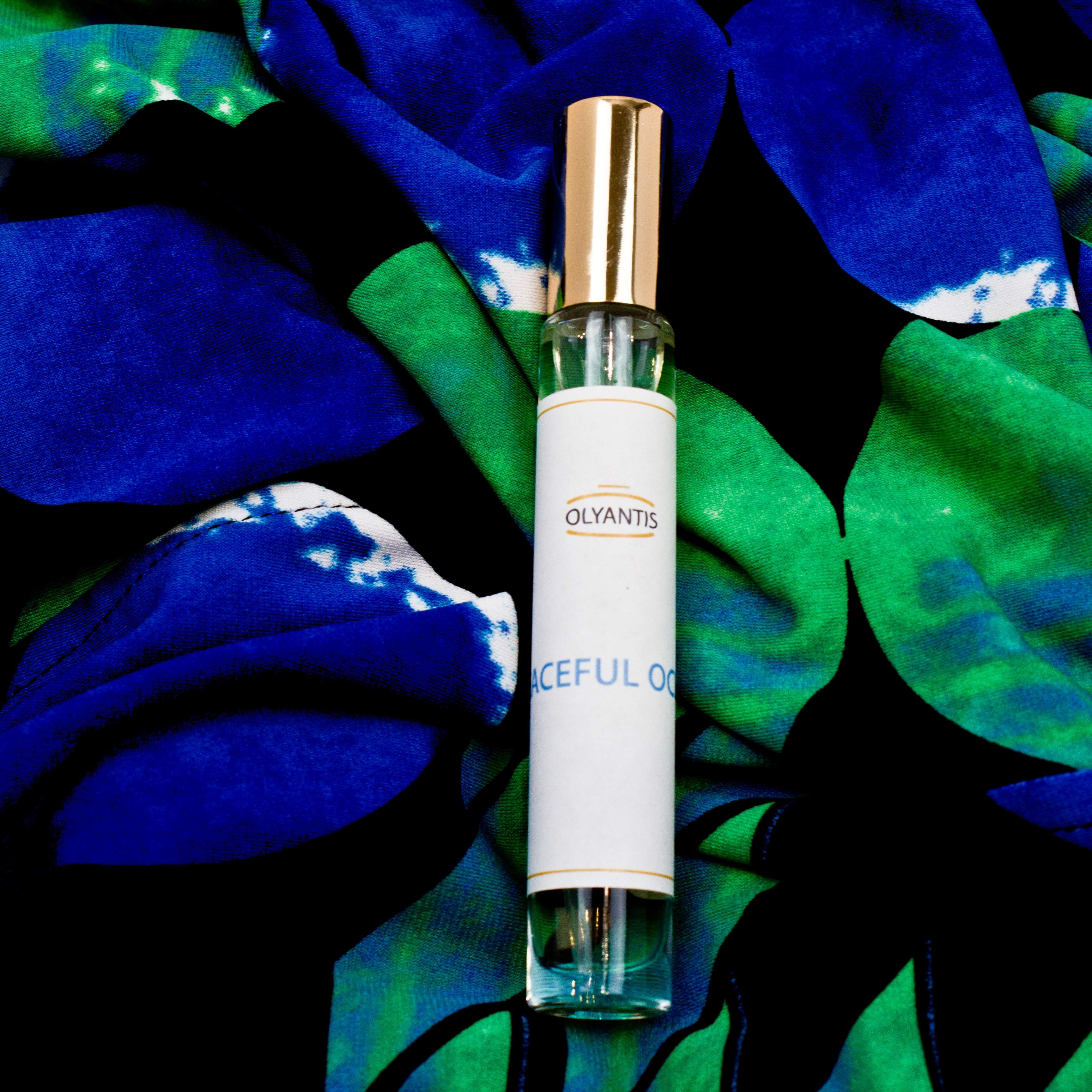 Olyantis 10 ml Peaceful Ocean eau de parfum bottle on a blue and green background.