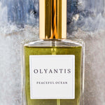 Olyantis's Peaceful Ocean Eau de Parfum, 60 ml, on grey-blue background. 