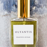 Olyantis's Peaceful Ocean Eau de Parfum, 60 ml, on grey-blue background. 