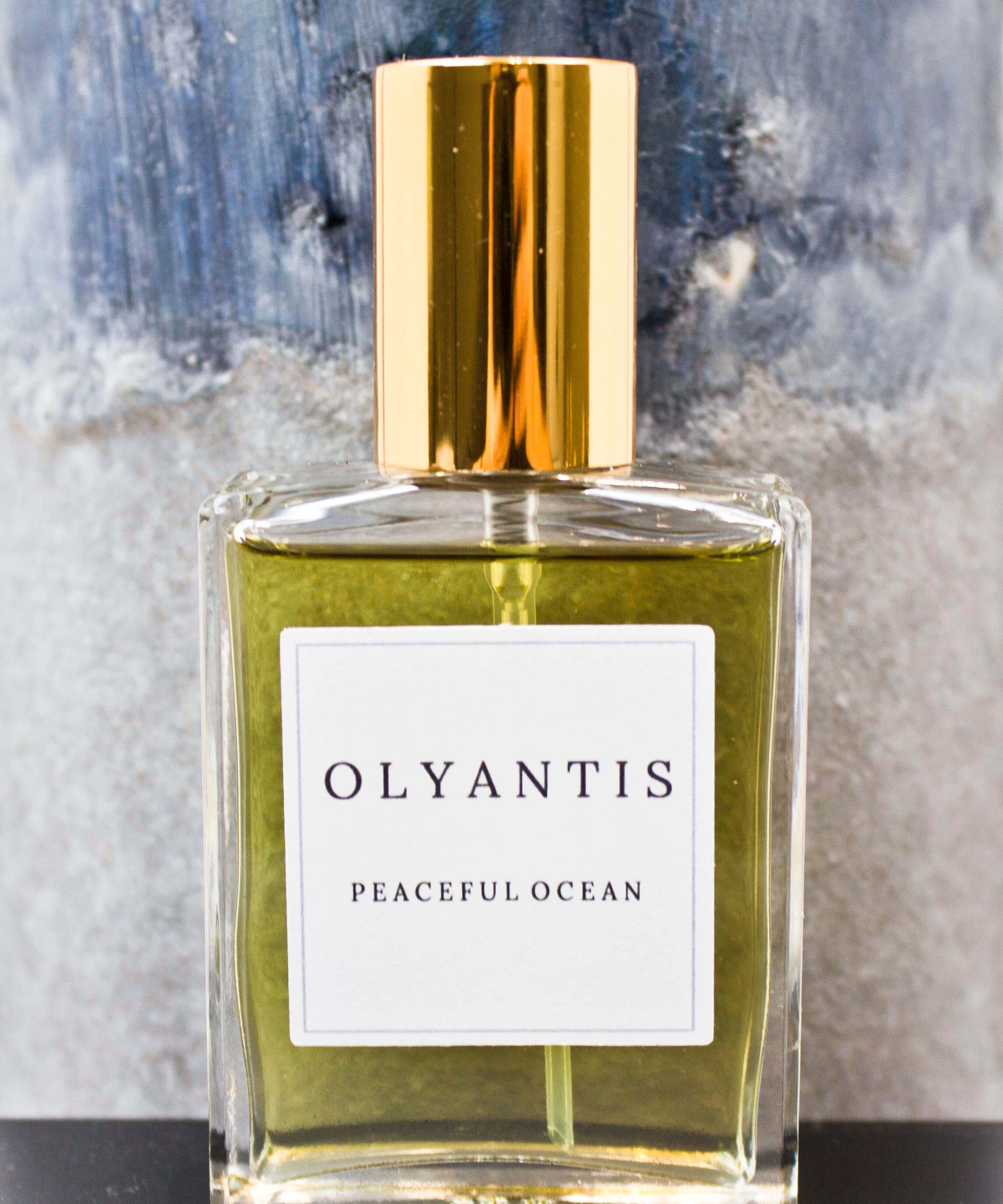 Olyantis's Peaceful Ocean Eau de Parfum, 60 ml, on grey-blue background. 