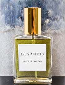 Olyantis's Peaceful Ocean Eau de Parfum, 60 ml, on grey-blue background. 