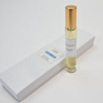 Olyantis's Peaceful Ocean 10 ml perfume glass bottle with gold cap beside its paper box. 