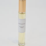 Olyantis's  Rapsodie D'Été 10 ml perfume glass bottle with gold cap on a white background.