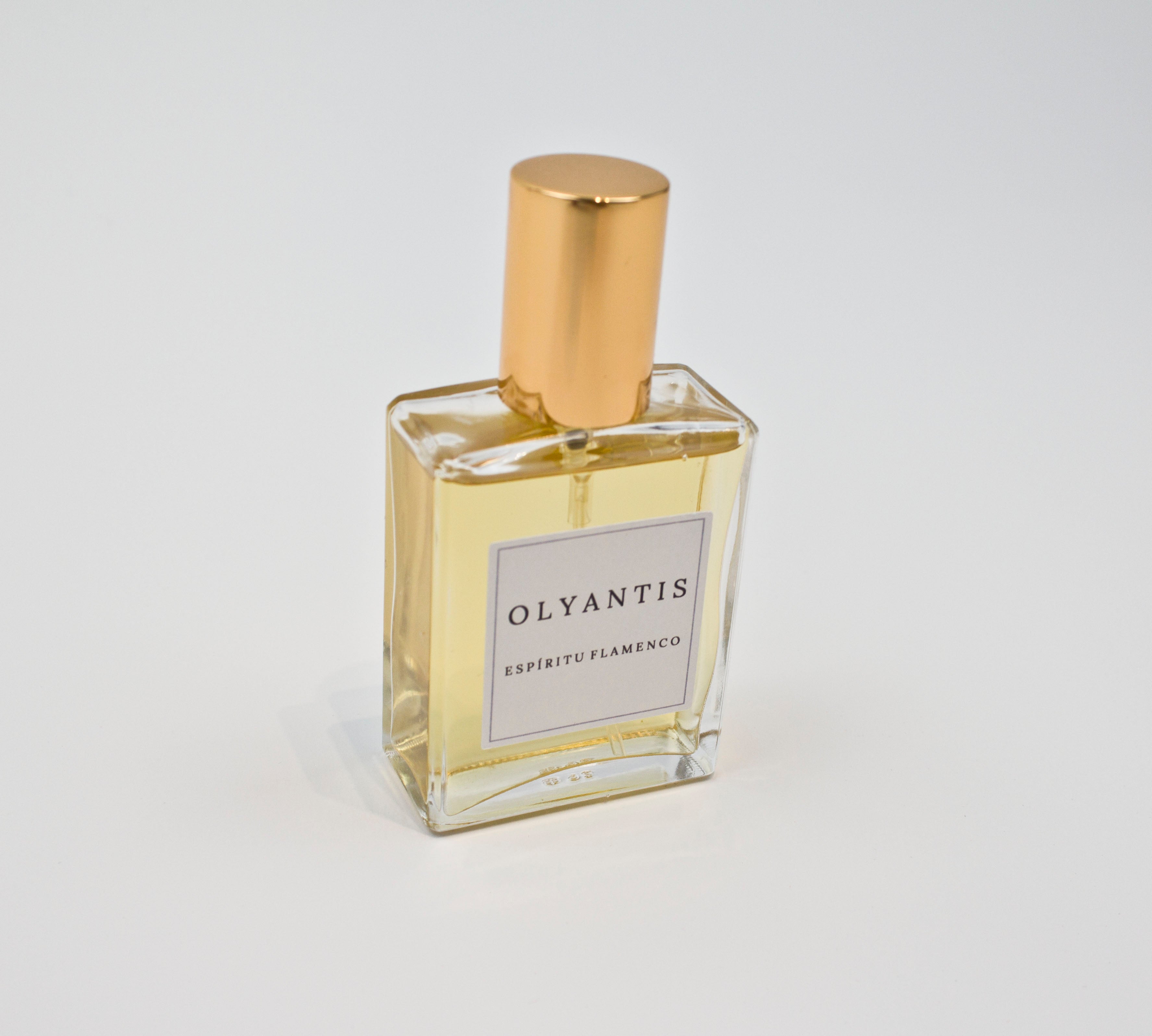 Olyantis's Espíritu Flamenco 60 ml perfume glass bottle with gold cap in an angle, on a white background.
