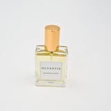 Olyantis's  Rapsodie D'Été 60 ml perfume glass bottle with gold cap on a white background.