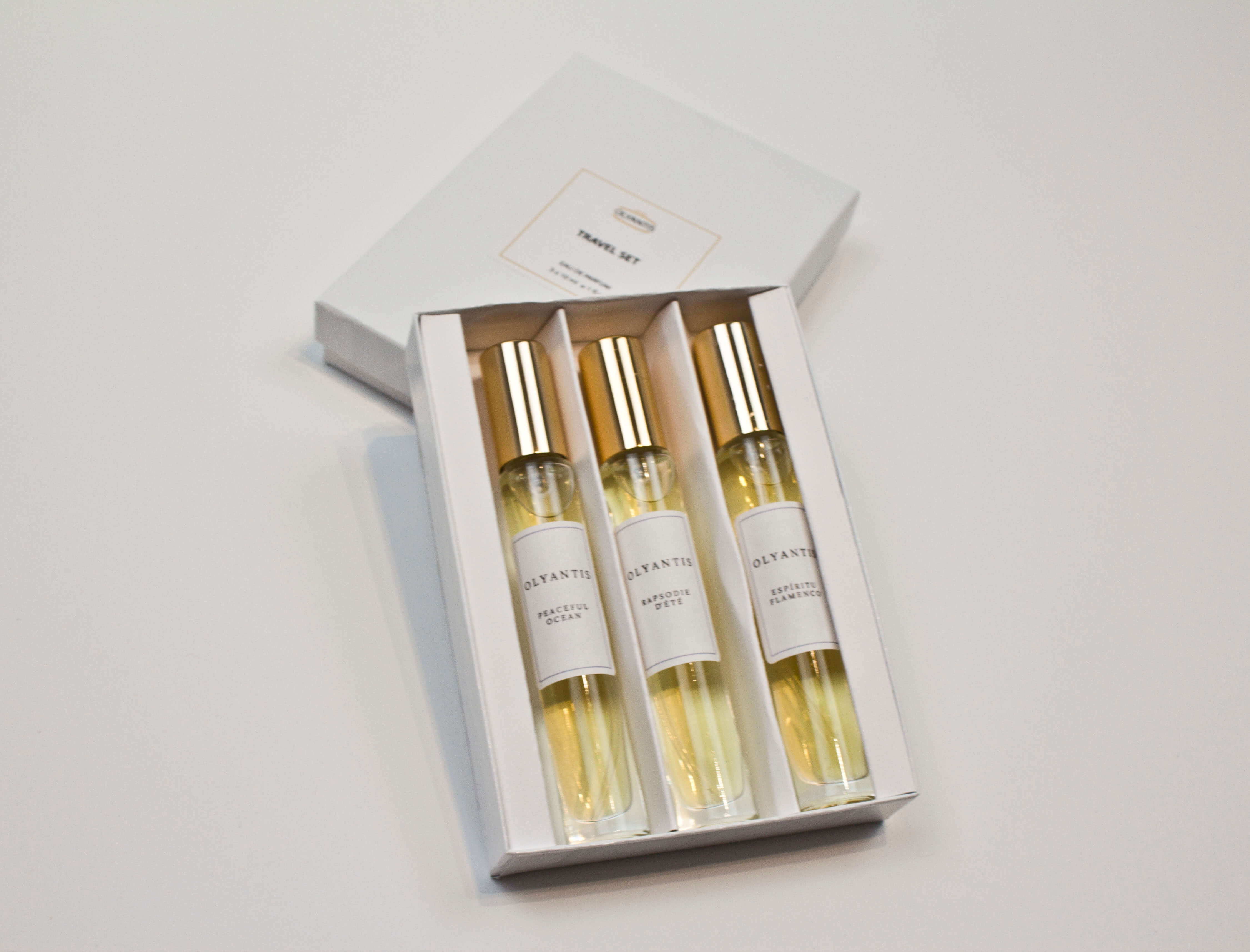 Olyantis's Travel Set of 3x 10 ml perfume glass bottles in its white box opened to display the perfume bottles. 