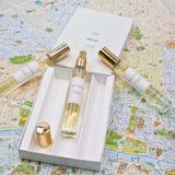 Olyantis's Travel Set of 3x 10 ml perfume glass bottles, on with golden cap off, in its opened box, on Montpellier’s ( France) city map. 