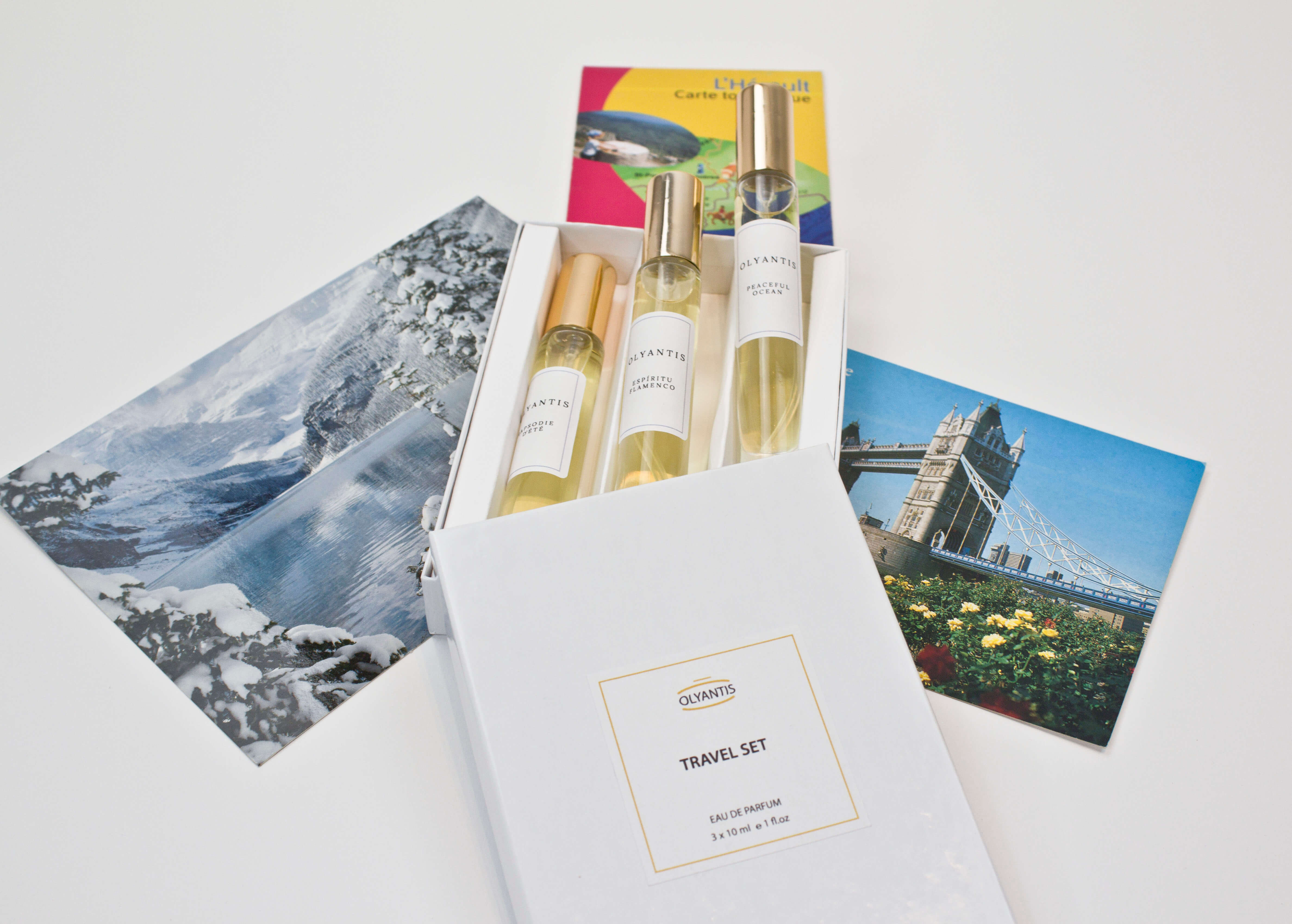 Olyantis's Travel Set of 3x 10 ml perfume glass bottles on 3 postcards from 3 different global destinations, including Lake Louise in Canada, London UK, and south of France. 